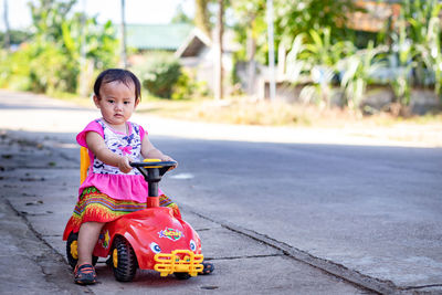 Cute boy sitting on road