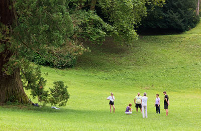 Group of people walking on golf course