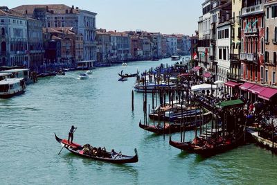 Boats in river with city in background