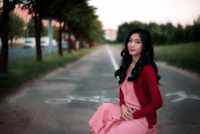 Portrait of young woman sitting outdoors