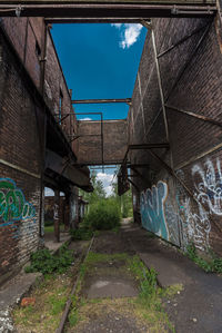 Empty alley amidst buildings in city