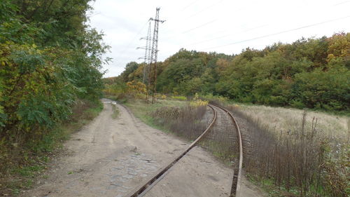 Railroad track amidst trees against sky