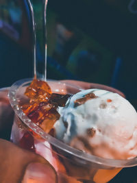 Close-up of hand holding ice cream