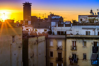 Buildings in city at sunset