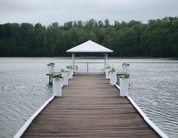 Wooden pier over lake against sky