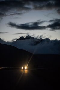 Scenic view of silhouette field against sky at sunset