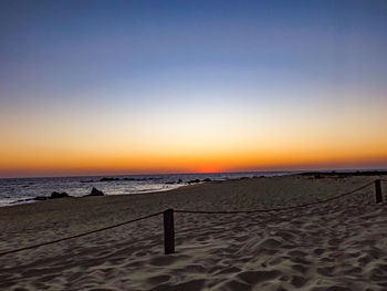 Scenic view of beach against sky during sunset
