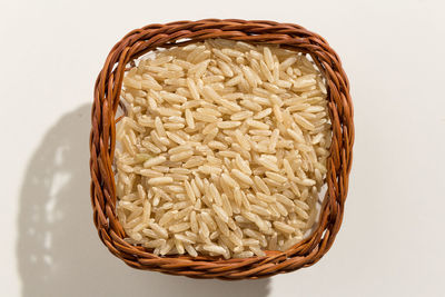 High angle view of bread in basket against white background