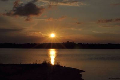 Scenic view of lake at sunset