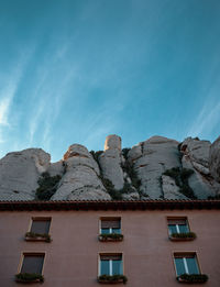 Low angle view of buildings against blue sky