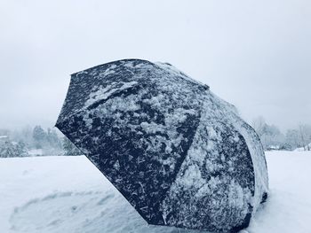 Snow covered land against sky