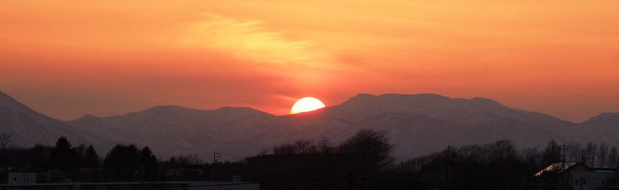 Scenic view of silhouette mountains against sky at sunset