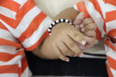 Close-up of boys holding hands