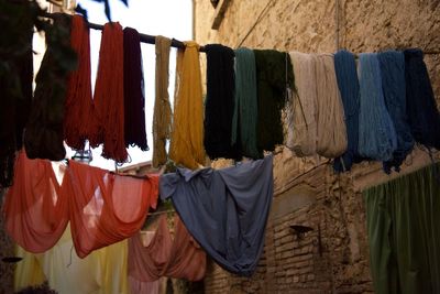 Strings of wool and fabric hung out to dry