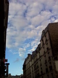 Low angle view of building against cloudy sky