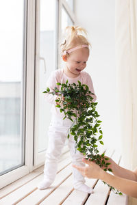 Portrait of young woman holding bouquet