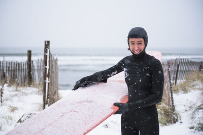 Woman going surfing during winter snow