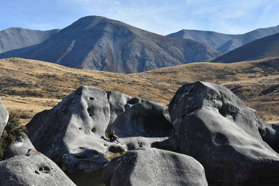 Scenic view of rocks in mountains against sky