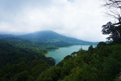 Scenic view of lake and mountains against sky