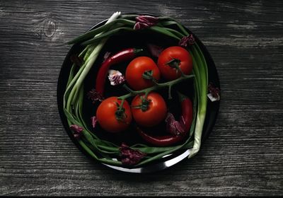 High angle view of tomatoes in basket on table