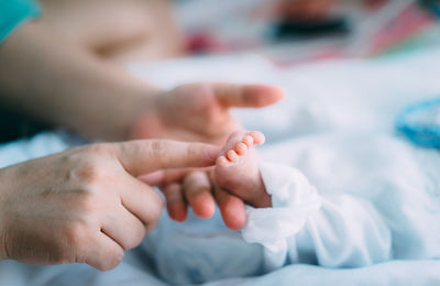 Midsection of couple holding hands