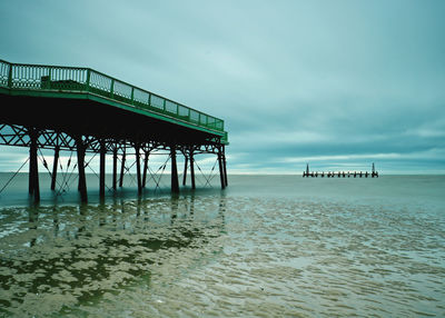 Pier over sea against sky