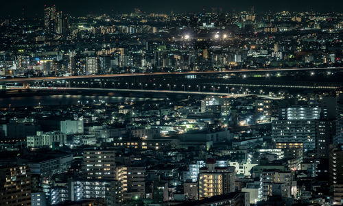 High angle view of illuminated city buildings at night