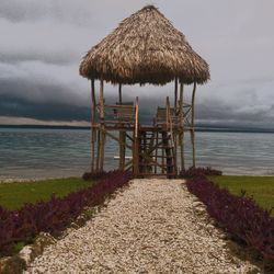 Lifeguard hut on beach against sky