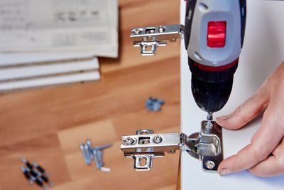 Cropped hand of man repairing car
