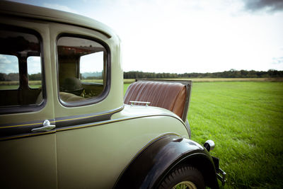 Car on field against sky