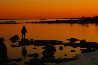 Silhouette people at beach during sunset