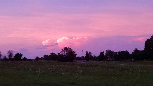 Scenic view of field against cloudy sky