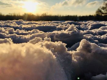 Scenic view of snow covered landscape against sky during sunset