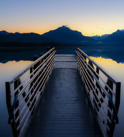 Pier over sea against sky during sunset