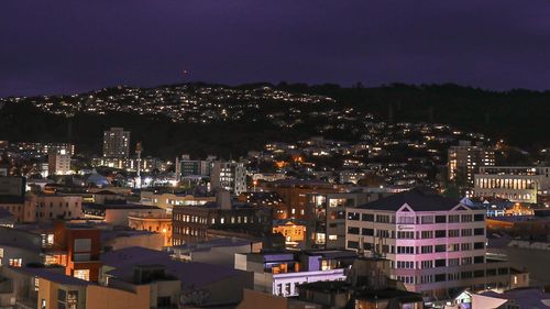 High angle view of illuminated city buildings at dusk