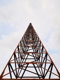 Low angle view of silhouette electricity pylon against sky