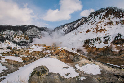 Scenic view of snowcapped mountains against sky