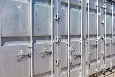 Detailed close up view on metal and steel surfaces on a silver cargo containter