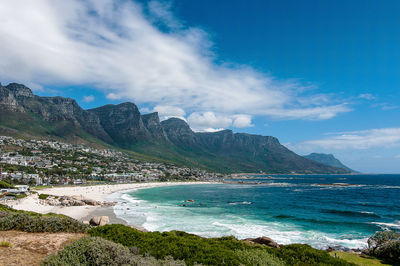 Scenic view of mountain range against cloudy sky