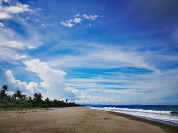View of beach against cloudy sky