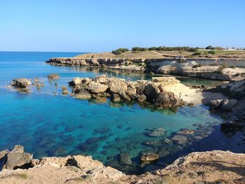 Scenic view of sea against clear blue sky / blue rocky beach / blue sea