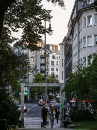 People on street amidst buildings in city