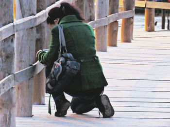 Full length of woman standing on bench