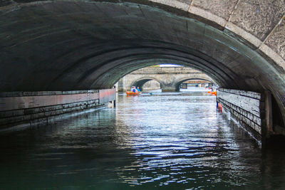 Arch bridge over river in tunnel