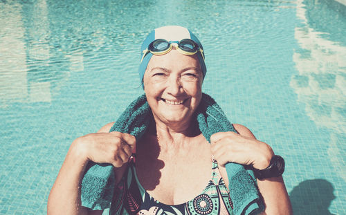 Portrait of smiling senior woman in swimming pool