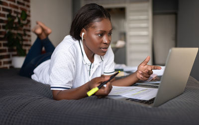 Ethnic student discussing data during video chat