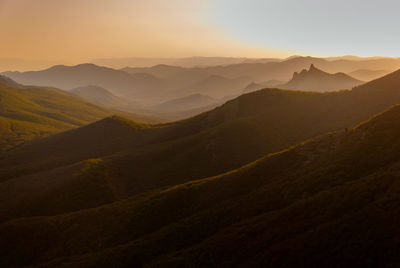 Scenic view of mountains against sky at sunset