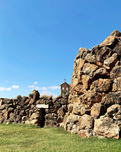 Stone wall on field against clear blue sky, nuraghe, sardegna