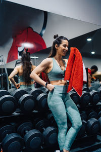 Portrait of smiling friends sitting in gym