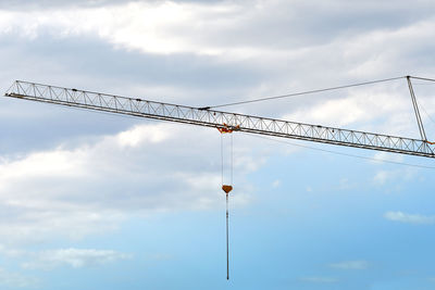 Low angle view of crane against sky